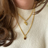 Gold BFF necklace styled with Heart Claw Lock Necklace from front angle