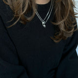 Silver BFF necklace with winged heart pendant styled