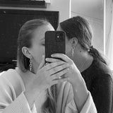 Long silver Alice earrings with spike detail, styled by two people