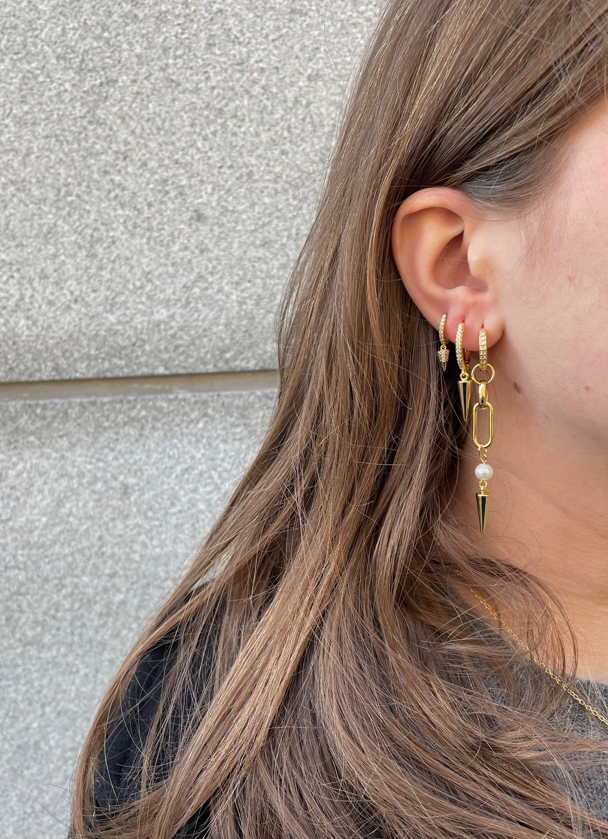 Adora Earrings in gold styled with ear stack and layered spike earrings