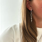 Adora Earrings in silver with pearl and spike, worn with heart pendant necklace