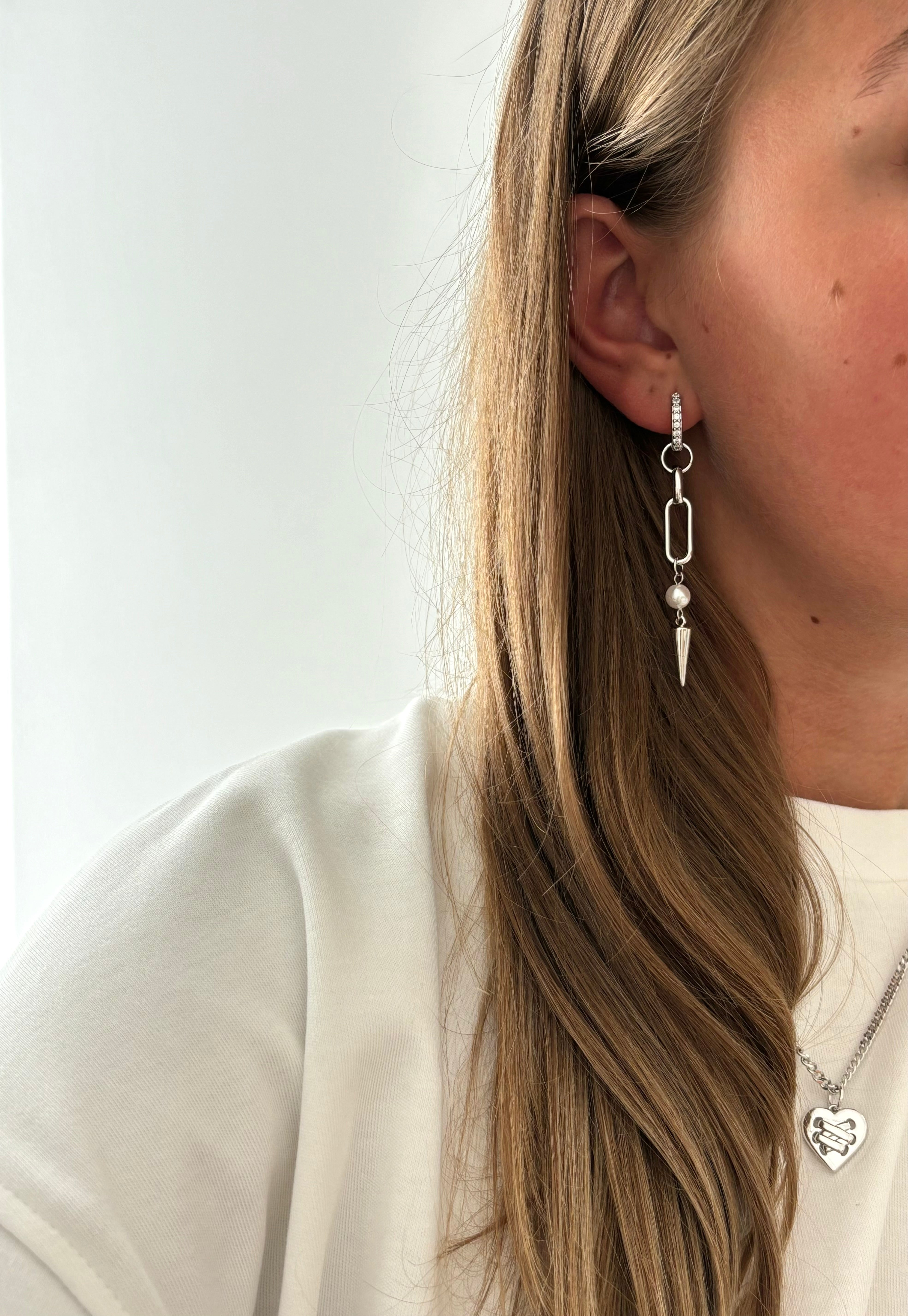 Adora Earrings in silver with pearl and spike, worn with heart pendant necklace