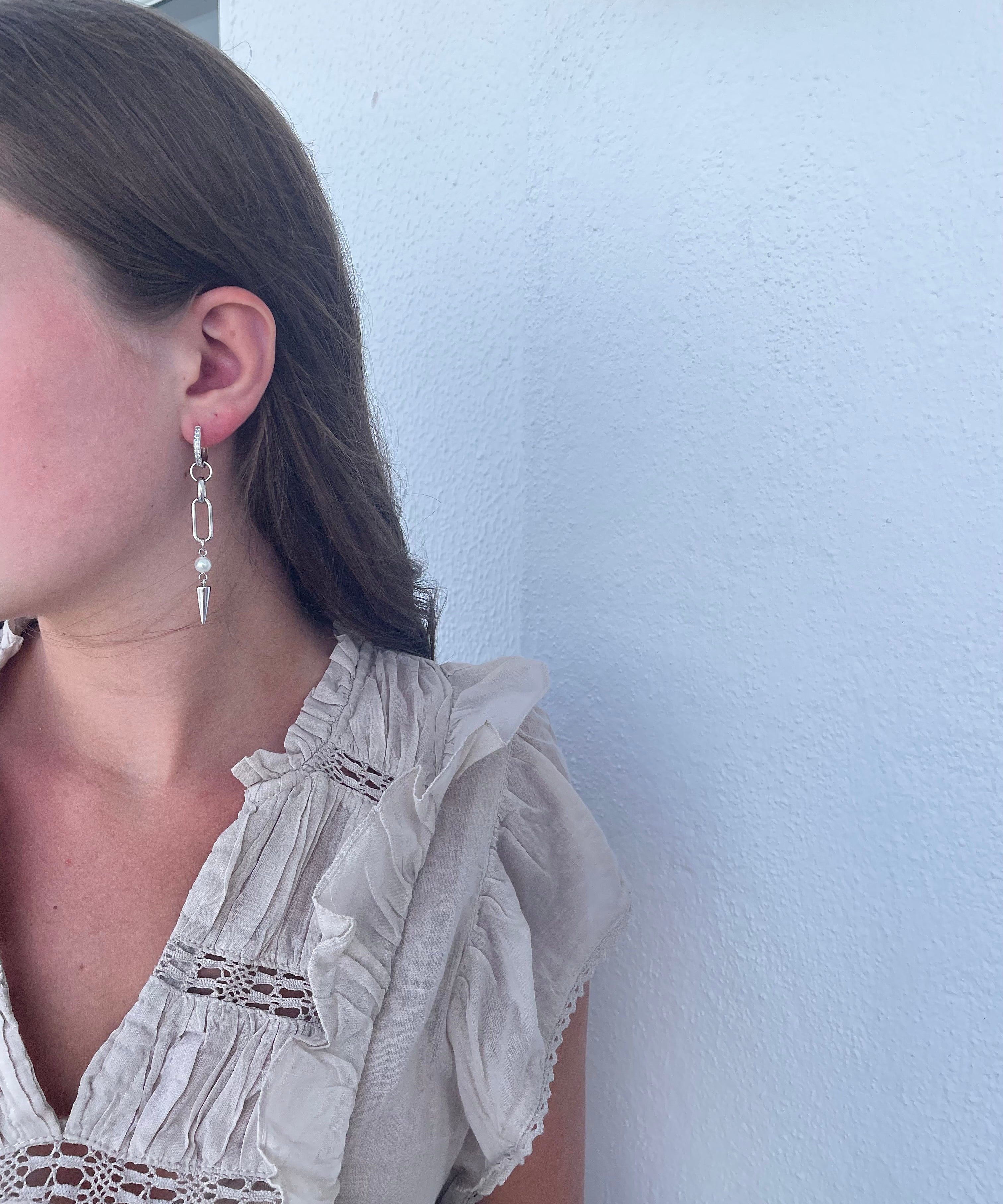 Adora Earrings in silver with pearl and spike, worn in side angle