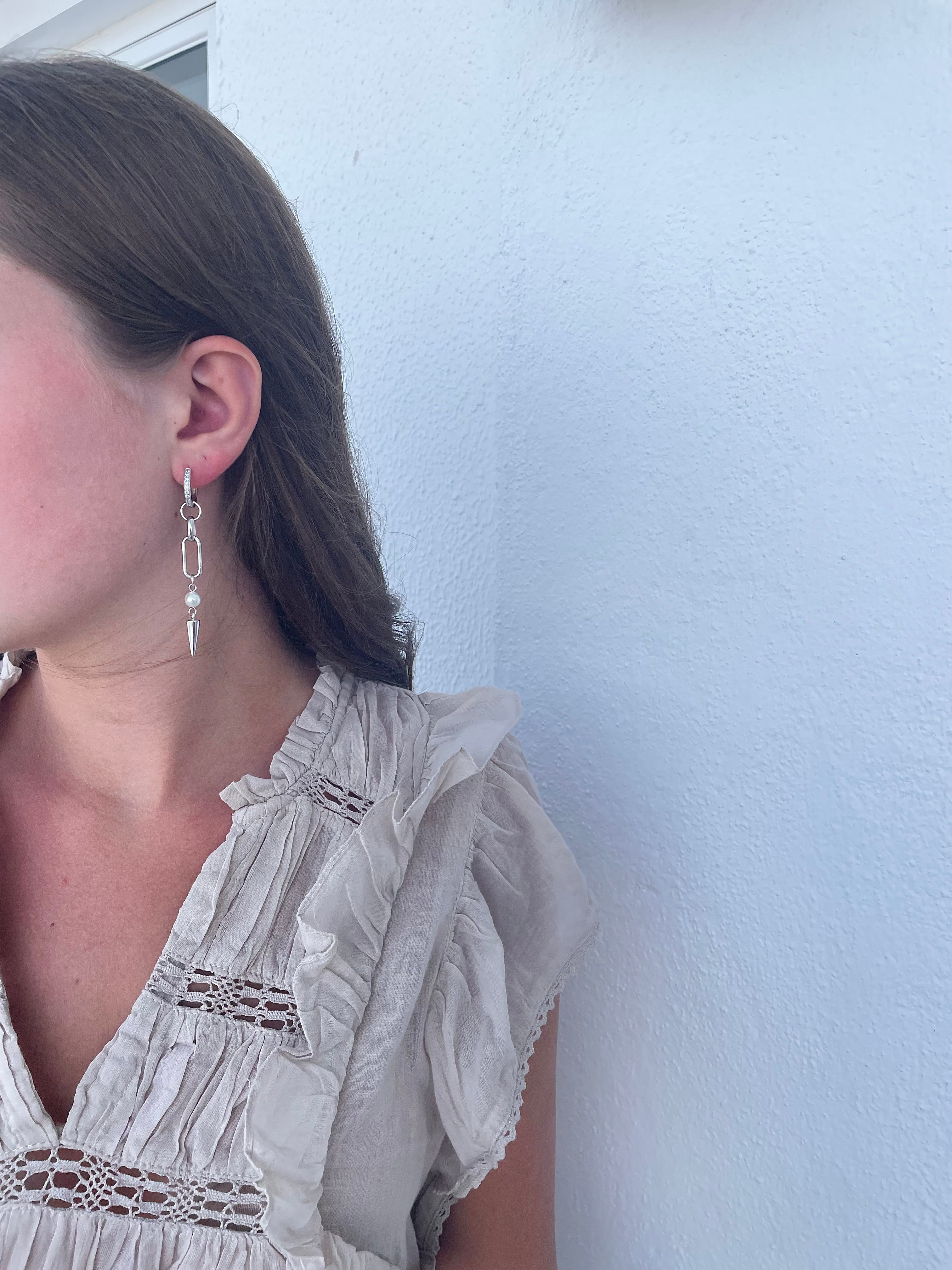 Adora Earrings in silver with pearl and spike, worn in side angle