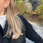 gold alice earrings stacked with hoop earring from side