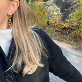 gold alice earrings stacked with hoop earring from side