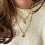 Gold BFF necklace styled with Heart Claw Lock Necklace from front angle
