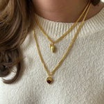 Gold BFF necklace stacked with red Heart Claw Lock Necklace