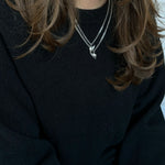 Silver BFF necklace with winged heart pendant styled